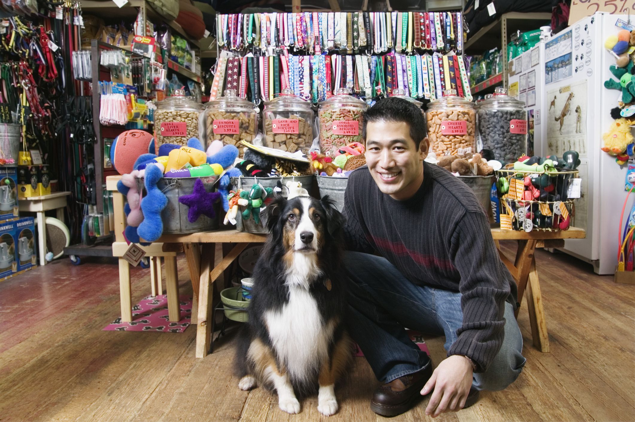 Dog and man in colorful pet store.